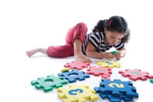 Girl concentrating on puzzle pieces