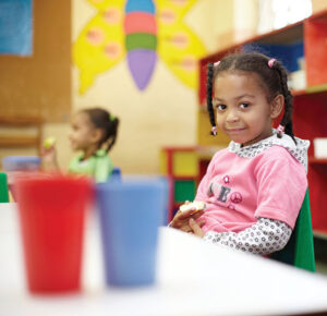 Girl Sitting with Cups