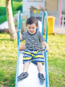 Boy Sliding Down a Slide