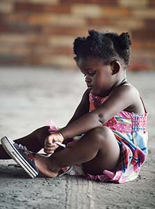 Girl putting on her shoe