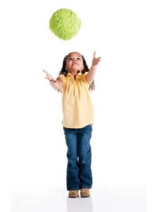 Girl tossing ball