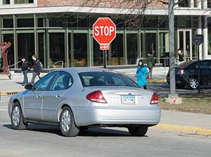 Picture of a car stopped at a stop sign