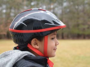 Picture of a young boy wearing a bicycle helmet