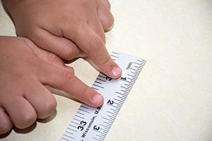 Child measuring an inch