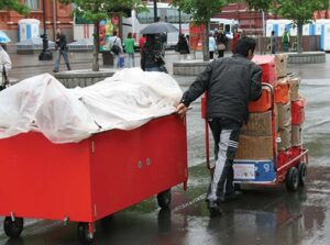 man pushing and pulling a cart