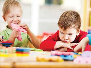 Angry looking boy looking at the toys