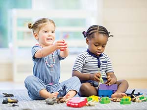 two girls playing with toys