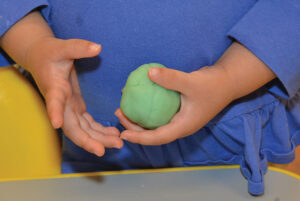 child with play dough