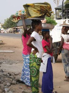 girls carrying baskets on head