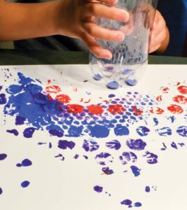 child painting with at drink bottle